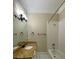Bright bathroom featuring a granite countertop, modern lighting, and a shower-tub combination with white tile at 9113 Oak Bluff Ct, Waxhaw, NC 28173
