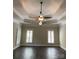 Open bedroom featuring dark hardwood floors, plantation shutters, crown molding, and dual ceiling fans at 9113 Oak Bluff Ct, Waxhaw, NC 28173
