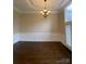 Formal dining room showcases wainscoting, a modern chandelier and plantation shutters at 9113 Oak Bluff Ct, Waxhaw, NC 28173