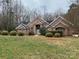 Charming single story brick home with arched entryway and well-manicured landscaping at 9113 Oak Bluff Ct, Waxhaw, NC 28173