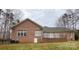 A view of the rear exterior of a beautiful single story brick house with many windows at 9113 Oak Bluff Ct, Waxhaw, NC 28173