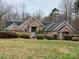 Charming single story brick home with arched entryway and well-manicured landscaping at 9113 Oak Bluff Ct, Waxhaw, NC 28173