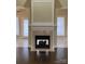 Close-up of a fireplace with beautiful tile surround and decorative mantel at 9113 Oak Bluff Ct, Waxhaw, NC 28173