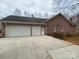 Attached garage featuring two doors and a spacious driveway at 9113 Oak Bluff Ct, Waxhaw, NC 28173