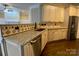 Stylish kitchen with stainless steel appliances, granite countertops, and custom cabinets at 9113 Oak Bluff Ct, Waxhaw, NC 28173