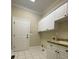 Functional laundry room featuring ample cabinet space, a utility sink, and tile flooring at 9113 Oak Bluff Ct, Waxhaw, NC 28173