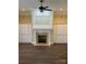 Bright living room with a cozy fireplace, custom built-in shelving and hardwood floors at 9113 Oak Bluff Ct, Waxhaw, NC 28173