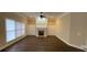 Spacious living room featuring hardwood floors, a fireplace, built-in shelving and large windows at 9113 Oak Bluff Ct, Waxhaw, NC 28173