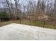 View from the open concrete patio with iron guardrails looking out at a wooded area at 9113 Oak Bluff Ct, Waxhaw, NC 28173