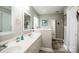 Bright bathroom features a double vanity, lots of cabinet space, and decorative mirrors at 1050 Emerson Dr, Mooresville, NC 28115