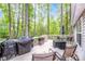 Spacious wooden deck with outdoor furniture, grill, and serene views of surrounding trees and foliage at 1050 Emerson Dr, Mooresville, NC 28115