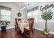 Elegant dining room with hardwood floors, natural light, and a tastefully decorated table at 1050 Emerson Dr, Mooresville, NC 28115