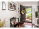 Inviting entryway with hardwood floors, a decorative bench, and a view of the front yard through the open door at 1050 Emerson Dr, Mooresville, NC 28115