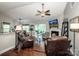 Cozy living room featuring hardwood floors, a fireplace, and a sunroom with ample natural light at 1050 Emerson Dr, Mooresville, NC 28115