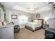 Cozy main bedroom featuring a comfortable bed, tray ceiling, and neutral decor at 1050 Emerson Dr, Mooresville, NC 28115