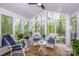 Bright sunroom with lots of natural light, stylish seating, and views of lush greenery at 1050 Emerson Dr, Mooresville, NC 28115