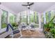 Bright sunroom with lots of natural light, stylish seating, and views of lush greenery at 1050 Emerson Dr, Mooresville, NC 28115
