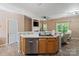 Open kitchen featuring stainless steel dishwasher and kitchen island with sink at 1097 Constitution Park Blvd, Rock Hill, SC 29732