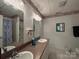 Full bathroom with double sinks, large mirror and shower-tub combination at 1224 Island Creek Dr, Troy, NC 27371