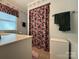 Well-lit bathroom featuring a floral shower curtain and a modern vanity at 1224 Island Creek Dr, Troy, NC 27371