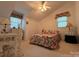 Cozy bedroom with floral bedding, complemented by natural light from two windows and a classic wicker desk at 1224 Island Creek Dr, Troy, NC 27371