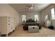 Bright bedroom with a plaid comforter, two windows, ceiling fan and white furniture at 1224 Island Creek Dr, Troy, NC 27371