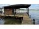 Exterior of wood boathouse featuring covered boat parking and wooden walkway at 1224 Island Creek Dr, Troy, NC 27371