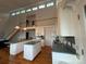 Spacious kitchen with a double island, ample cabinet space, and modern appliances, complemented by hardwood floors at 1224 Island Creek Dr, Troy, NC 27371