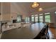 Bright kitchen features white cabinetry, long breakfast bar, kitchen island, and scenic views from many windows at 1224 Island Creek Dr, Troy, NC 27371