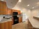 Modern kitchen with stainless steel appliances and light wood cabinets at 1224 Island Creek Dr, Troy, NC 27371