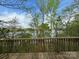 Picturesque view of the lake through the trees from the deck's wood railing at 1224 Island Creek Dr, Troy, NC 27371