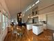 Expansive living area with high ceilings, a well-appointed kitchen, a dining area, and plentiful windows for natural light at 1224 Island Creek Dr, Troy, NC 27371