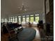Bright living room with hardwood floors, multiple windows offering scenic views, and a cozy fireplace for a relaxing atmosphere at 1224 Island Creek Dr, Troy, NC 27371
