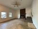 Spacious living room with a red brick fireplace, ceiling fan and staircase on the right at 1224 Island Creek Dr, Troy, NC 27371