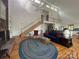 Inviting living room with a brick fireplace, soaring ceilings, a staircase, and large windows for abundant natural light at 1224 Island Creek Dr, Troy, NC 27371