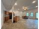 Open concept living area featuring a small kitchen, dining area, recessed lights and exterior doors at 1224 Island Creek Dr, Troy, NC 27371