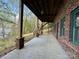 Spacious outdoor patio featuring brick columns and wood ceilings that face towards the water at 1224 Island Creek Dr, Troy, NC 27371