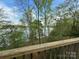 Picturesque view of the lake through the lush trees, seen from the deck at 1224 Island Creek Dr, Troy, NC 27371
