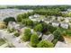 An aerial view shows houses nestled among lush green trees in a peaceful residential neighborhood at 12319 Cumberland Cove Dr, Charlotte, NC 28273
