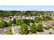 An aerial view shows a neighborhood of well-maintained homes surrounded by mature trees and green spaces at 12319 Cumberland Cove Dr, Charlotte, NC 28273