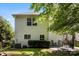 Back of the house featuring a covered patio, lush lawn, and manicured landscaping at 12319 Cumberland Cove Dr, Charlotte, NC 28273
