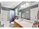 Bathroom featuring a tub/shower combo, a large vanity, neutral tile flooring, and grey walls at 12319 Cumberland Cove Dr, Charlotte, NC 28273