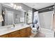 Bright bathroom showcasing a double sink vanity, a bathtub with shower, and neutral finishes at 12319 Cumberland Cove Dr, Charlotte, NC 28273