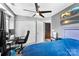 Bedroom featuring carpet, neutral walls, large window, ceiling fan, and a workstation at 12319 Cumberland Cove Dr, Charlotte, NC 28273