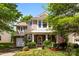 Charming two-story home featuring a brick and siding facade, a welcoming porch, and lush landscaping at 12319 Cumberland Cove Dr, Charlotte, NC 28273