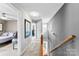 Carpeted upstairs hallway with wooden railing leading to bedrooms and other living spaces at 12319 Cumberland Cove Dr, Charlotte, NC 28273