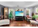 Comfortable living room with a large TV, wood floors, and ample seating at 12319 Cumberland Cove Dr, Charlotte, NC 28273
