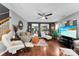 Open-concept living room featuring hardwood floors, modern furnishings, and plenty of natural light at 12319 Cumberland Cove Dr, Charlotte, NC 28273