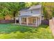 Spacious backyard featuring a covered patio and green lawn perfect for outdoor entertaining at 13206 Meadowmere Rd, Huntersville, NC 28078