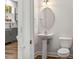Bright half bathroom featuring modern fixtures and an oval mirror at 13206 Meadowmere Rd, Huntersville, NC 28078